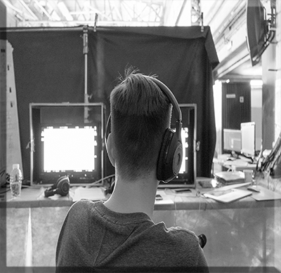 Creative Director film-director-with-headphones-in-front-of-monitors Creative directors are the glue