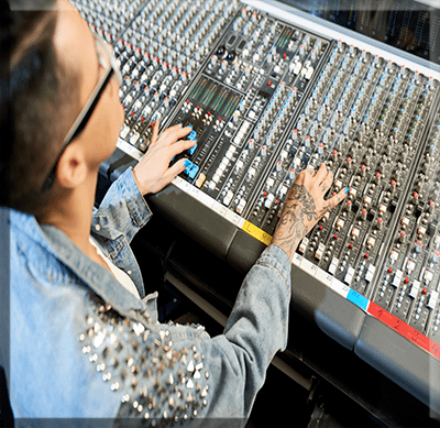 Sound Desk Operators tattooed-working-on-control-console Sound Designers to supervise the whole sound post production