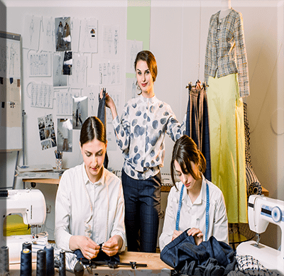 pretty-seamstresses-sewing-at-their-workshop Iconic seamstress sewing at our workshop In the USA